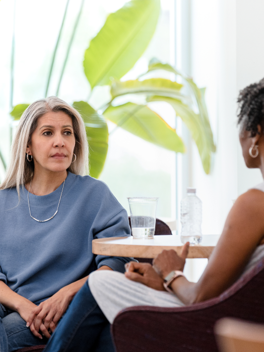 serious mature woman listens to female therapist