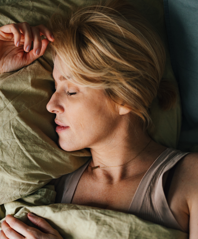 top view of woman sleeping in bed