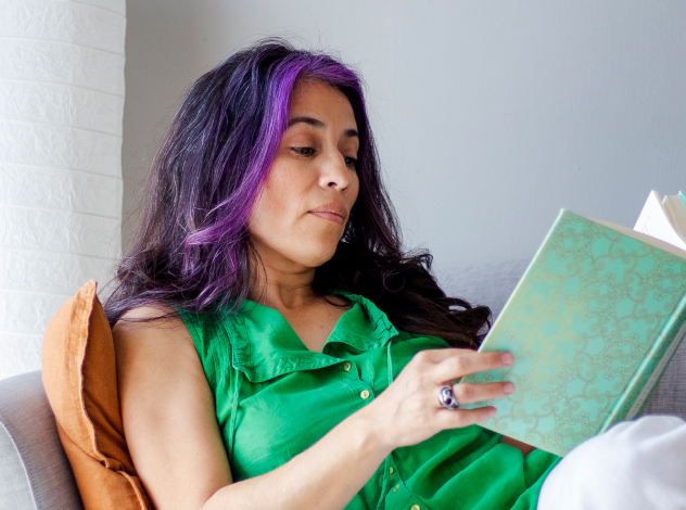 woman reading book resting on the lounge sofa